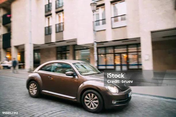 Вид Сбоку Коричневого Volkswagen Новый Хэтчбек Beetle Купе Автомобиль В — стоковые фотографии и другие картинки Volkswagen Beetle